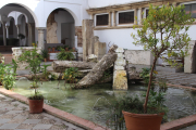 Water feature with modern sculpture in restored villa