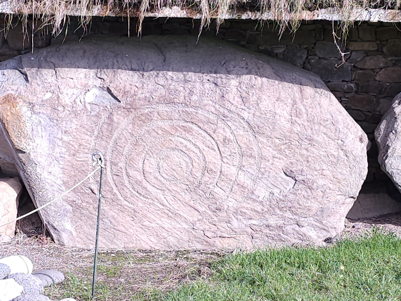 Carved stones like this surround the base of the mounds at Knowth and Newgrange to help keep the mound in place.