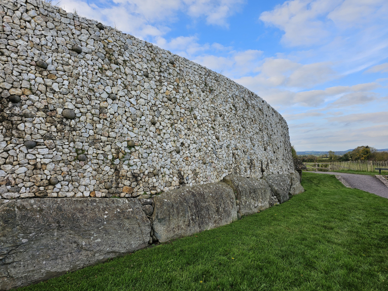 Part of the curved wall at Newgrange. There is controversy about how the wall was restored.