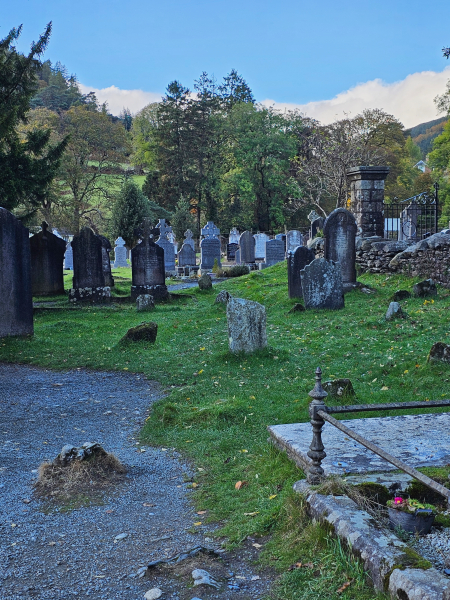 Old gravestones in a green Irish field at Glendalough.