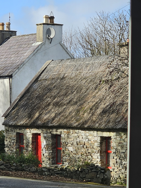 Another thatched roof and red door