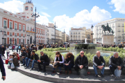 People pretending to be warm in the plaza