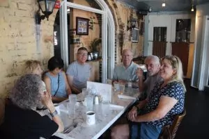 Group seated at Huey's restaurant table.